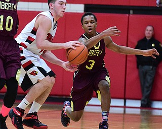 CANFIELD, OHIO - JANUARY 10, 2015: Kaylon Davis #3 of Liberty swipes the ball out of the hands of Mike Yourstowsky #14 of Canfield during the 2nd half of Saturday nights game at Canfield High School. (Photo by David Dermer/Youngstown Vindicator)