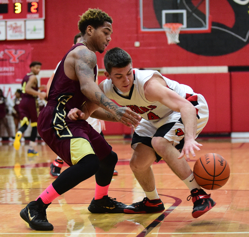 CANFIELD, OHIO - JANUARY 10, 2015: Mike Yourstowsky #14 of Canfield chases after the ball after having it poked out of his hands by Lynn Bowden #10 of Liberty during the 2nd half of Saturday nights game at Canfield High School. (Photo by David Dermer/Youngstown Vindicator)