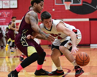 CANFIELD, OHIO - JANUARY 10, 2015: Mike Yourstowsky #14 of Canfield chases after the ball after having it poked out of his hands by Lynn Bowden #10 of Liberty during the 2nd half of Saturday nights game at Canfield High School. (Photo by David Dermer/Youngstown Vindicator)