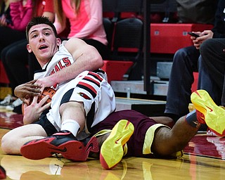 CANFIELD, OHIO - JANUARY 10, 2015: Mike Yourstowsky #14 of Canfield rips the ball away from Leslie Carter #2 of Liberty while laying on his back during the 2nd half of Saturday nights game at Canfield High School. (Photo by David Dermer/Youngstown Vindicator)