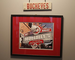        ROBERT K. YOSAY  | THE VINDICATOR..OSU Buckeye Fan Jim Mullally  of Poland and the entrance way to the basement...and his basement painted scarlet and gay a