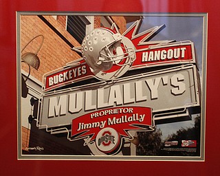        ROBERT K. YOSAY  | THE VINDICATOR..OSU Buckeye Fan Jim Mullally  of Poland and the entrance way to the basement...and his basement painted scarlet and gay a