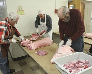 William D Lewis the Vindicator Preparing pork for sausage at Mt. Olivet Church in North Lima are from left: LeRoy Herrick, John Shepas and Larry Wassen.