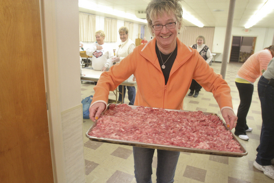 William D Lewis the Vindicator Rev. Melinda Quellhorst pastor of Mt Olivet Church in noth Lima carries a tray of sausage her church members are making for shrove tuesday pancake sausage  event.