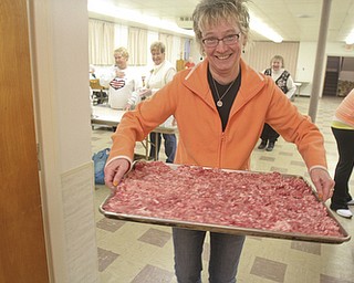 William D Lewis the Vindicator Rev. Melinda Quellhorst pastor of Mt Olivet Church in noth Lima carries a tray of sausage her church members are making for shrove tuesday pancake sausage  event.
