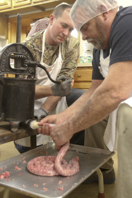 William D Lewis the VindicatorJohn Crouse, left, and Jerry guterba make sausage at Mt Olivet Church in north Lima in preparation for Shrove Tuesday event. The sausage maker in pix has been in Guterba's family since the late 1800's.