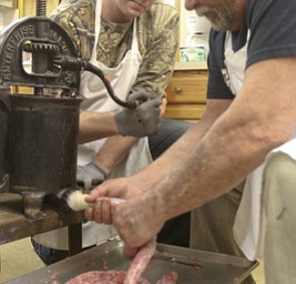 William D Lewis the VindicatorJohn Crouse, left, and Jerry guterba make sausage at Mt Olivet Church in north Lima in preparation for Shrove Tuesday event. The sausage maker in pix has been in Guterba's family since the late 1800's.