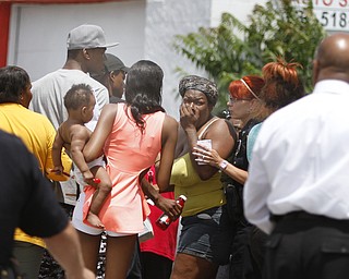        ROBERT K. YOSAY  | THE VINDICATOR.. .The owner of a South Avenue store and a 10-year-old boy were in the wrong place at the wrong time early Wednesday afternoon, as both were wounded as two men were shooting at each other..Both victims were taken to St. Elizabeth Health Center after the shooting at the 3211 South Ave. store about 1:25 p.m..The shooters got away..