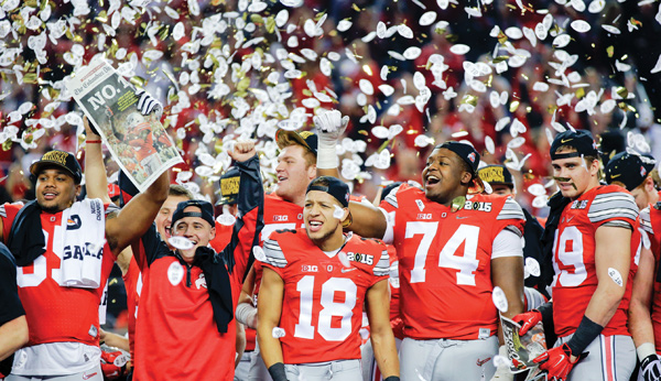 Ohio State players celebrate after the No. 4 Buckeyes defeated the No. 2 Oregon Ducks, 42-20, in the inaugural College Football Playoff championship Monday at AT&T Stadium in Arlington, Texas.