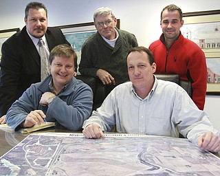 William D. Lewis the Vindicator Skip Members of Poland Activity Center committee look over maps of the area where center is to be built. Front l-r Skip Slavin, Ken Conzett, back l-r Zel Bush, Mike Heher and Ryan McBride.
