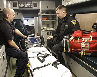        ROBERT K. YOSAY  | THE VINDICATOR..Austintown FD and Lane Ambulance coop is almost a year old .  It was a busy year and very successful for both -   Brandon Wirtz  Paramedic and ( AFD) and Ryan Caron ( Lane Ambulance) check the gear before starting their shift