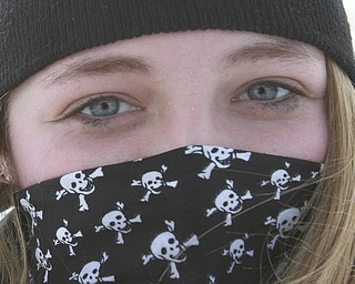 William D. Lewis the Vindicator  McKenna Gump, a student in Girard, keeps her face covered with a bandana  while spending a snow  trying to make a few dollars shoveling snow along Ward Ave. in Girard Wed 1-7-15. Cold temps, high wind and snow gave her plenty to do.