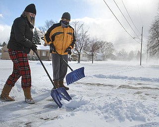 William D. Leiws the Vindicator McKenna Gump and her brother Haeden Gump,both students in Girard, spent thier snow day trying to make a few dollars shovelling snow along Ward Ave. in Girard Wed 1-7-15. Cold temps, high wind and snow gave them plenty to do.