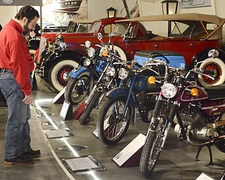 Katie Rickman | The Vindicator.Sid Marlin of Leavittsburg, Ohio walks down a display line of vintage motorcyles at the Antique Motorcycle Exhibit at the National Packard Museum on Friday evening.