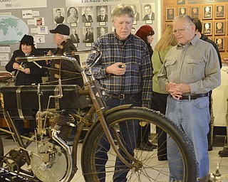 Katie Rickman | The Vindicator.David Santus of Butler, PA (on left) and Dan Mathey of Warren stand near the vintage 1905 Harley Davidson Belt Drive motorcycle which was the oldest bike on display at the Antique Motorcycle Exhibit at the National Packard Museum on Friday evening.