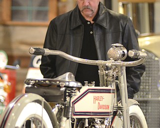 Katie Rickman | The Vindicator.John Lisko of Southington looks at a vintage motorcycle at the Antique Motorcycle Exhibit at the National Packard Museum on Friday evening.