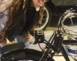 Katie Rickman | The Vindicator.Pete Knodel of Leavittsburg, Ohio takes a close look at a vintage 1923 Douglas W-23 at the Antique Motorcycle Exhibit at the National Packard Museum on Friday evening.