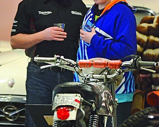 Katie Rickman | The Vindicator.Keith McCowin and his son 14-year-old son Krostpher (both of Liberty) look at a 1971 Greeves Path Finder at the Antique Motorcycle Exhibit at the National Packard Museum on Friday evening.