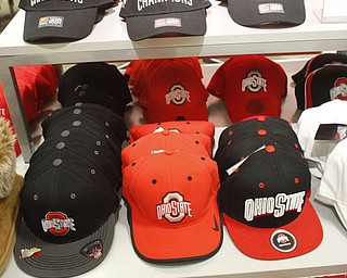        ROBERT K. YOSAY  | THE VINDICATOR...Jacob Rosa puts the new SUGAR BOWL CHAMPION hat on sale at PENNEYS .  along with other Ohio State jerseys etc...