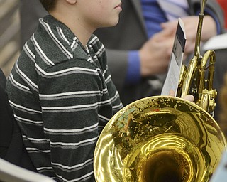 Katie Rickman | The Vindicator.Conner Hosa, 13 of Boardman, holds an instrument in his lap as he listens to Dr. Stace Mickens speak at the 3rd Annual YSU Horn Workshop on Sunday, Jan. 11, 2015.
