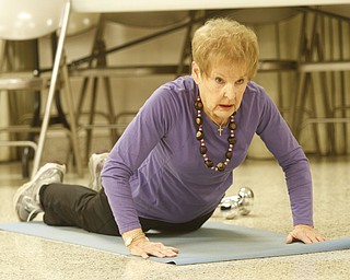        ROBERT K. YOSAY  | THE VINDICATOR..Buckeye necklace in tact as  Cookie Beeman.. does a sit up ..Fitness Fun -The total body workout class at St. Michael Church engages exercisers in warm up, weight trainiung, floor work, low-impact aerobics with s-t-r-e-t-c-h-ing and balancing and a cool-down period, u.Marion Calpin,