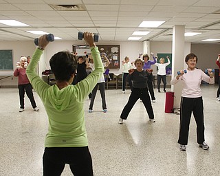        ROBERT K. YOSAY  | THE VINDICATOR..Mary Calpin with weights in hand.. leads the class... ..Fitness Fun -The total body workout class at St. Michael Church engages exercisers in warm up, weight trainiung, floor work, low-impact aerobics with s-t-r-e-t-c-h-ing and balancing and a cool-down period, u.Marion Calpin,