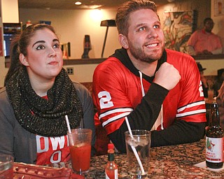 William D. Lewis The Vindicator  OSU fans Lauren Hunkis and Bobby Prodnick Jr of Girard watch a not so good play duringOSU game at Martini Bros Burger Bar in Youngstown 1-12-15.