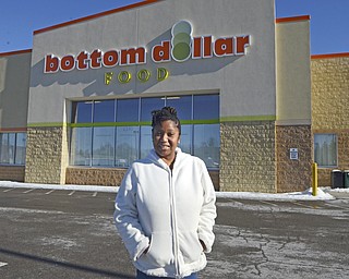 Katie Rickman | The Vindicator.Georgia Newton of Youngstown stands in front of the Bottom Dollar on Glennwood Ave. on January 13, 2015.  The Bottom Dollar stores closed much earlier than what was planned.