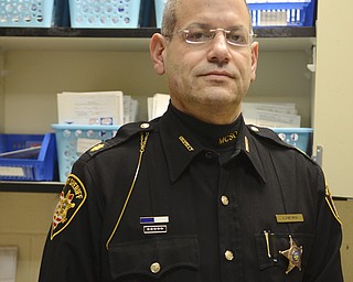Katie Rickman | The Vindicator.Maj. Alki Santamas, the MC Justice Center Administrator poses for a photo in front of a cupboard filled with medicine in the Medical Pod at the county jail on Tuesday, Jan. 13, 2015.