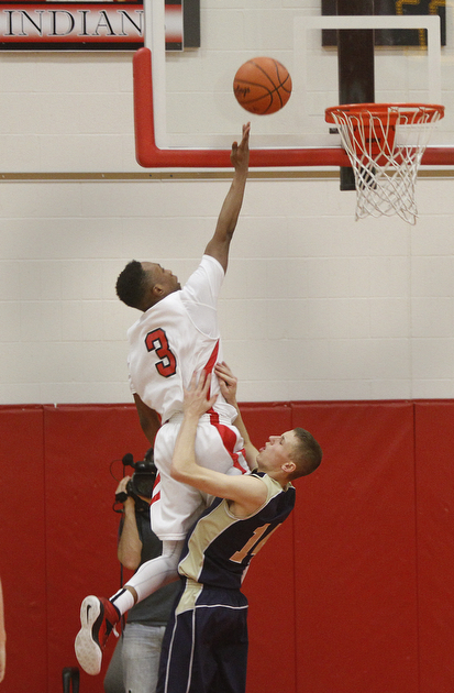        ROBERT K. YOSAY  | THE VINDICATOR..Easy 2 pointer as Girards #3 DeOnte Brown goes up and over Brookfield defender #14 ,Derrick Dickson  and a knee to the chest to help out..Brookfield at Girard ..
