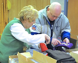 Jeff Lange | The Vindicator  Mark Sefcik  (right) of Youngstown negotiates a price with the church's council president Jeanette Weidner (left), Saturday morning at Bethlehem Lutheran Church in Youngstown.