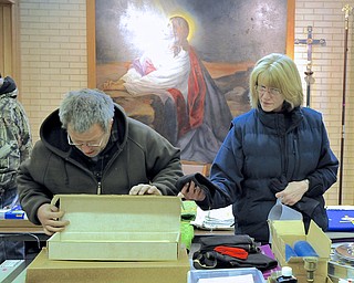 Jeff Lange | The Vindicator  David Gouldsberry (left) of Lisbon and Janice Rovnak of Youngstown browse the selection of goods for sale at Bethlehem Lutheran Church in Youngstown. The church conducted it's last service Dec. 28th.