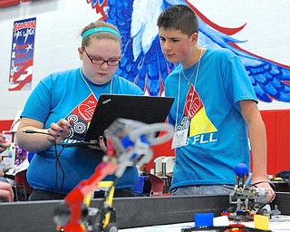 Jeff Lange | The Vindicator  Elise Yantes (left) and Brandon Malahtaris (right) both 8th graders at Austintown Fitch Middle school do some last-minute programming for their team S.M.A.R.T. Cookies before the competition, Saturday afternoon at Austintown Middle School.