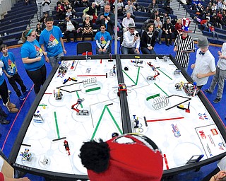 Jeff Lange | The Vindicator  Austintown S.M.A.R.T. Cookies (in blue) watch as their robot takes on the course against Aurora's team Slightly Different during the second round of the competition, Saturday afternoon at Austintown Fitch Middle School.