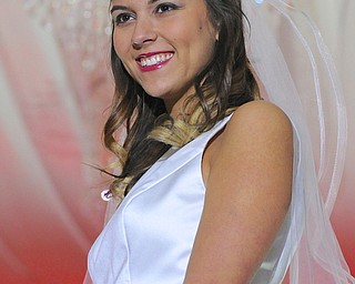 Jeff Lange | The Vindicator  Daniella Carson of Girard smiles and looks around as she poses while wearing a dress from Latest Trends in Bridal Trends, Sunday afternoon at the Eastwood Mall in Niles during the 2015 Bridal Extravaganza Fashion Show.
