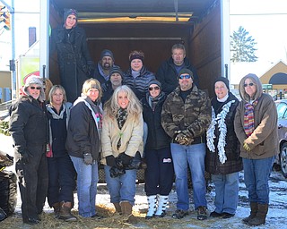 Members from Legacy Dog Rescue, Never Muzzled and Youngstown Dogs Surviving the Streets pass out free straw to help line dog houses for the winter at the Family Video in Girard on Jan. 10. Linda Liguori of Never Muzzled said there is enough sraw to help cover 180 dog houses.