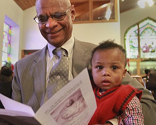 William D Lewis The Vindicator Rev. George H. Johnson of Agape Assembly church in Warren holds his grandson Ethan Johnson, 11 months, during Rev. Martin Luther King Jr. Community Worship Service  Sunday at Tabernacle Baptist Church in Youngstown. Rev. Johnson is the father of Rev Todd Johnson, pastor at Agape Assembly who was the main speaker at the Sunday event.