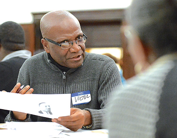 Victor Wan-Tatah of Youngstown State University’s Pan-African Studies program discusses with participants at his table the strengths and weaknesses that can help or hinder people’s ability to live civilly in Mahoning County. The discussion was part of Monday’s 32nd annual Community Workshop Celebrating the Life & Legacy of the Rev. Dr. Martin Luther King Jr. at First Presbyterian Church.