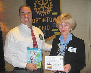 SPECIAL TO THE VINDICATOR — Kathy Mock, director of education and initiatives for United Way of Mahoning County, spoke at the Jan. 12 meeting of the Rotary Club of Austintown. She spoke about UW’s main literacy programs and congratulated the Rotary on its dictionary project for third-graders, reading program for second-graders and the library donation project, in which Rotary guest speakers have a book in their name donated to the Austintown Elementary School Library. Above, Rotary President Vince Colaluca presents Mock with a book to be donated in her honor.