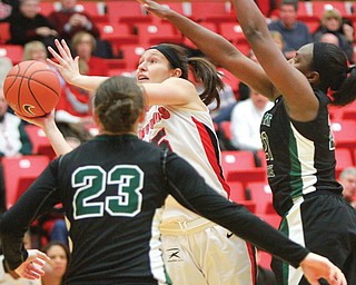 Youngstown State senior forward Heidi Schlegel shoots under pressure from Wright State forward Tayler Stanton (21) and guard Courtney Boyd (23) during their Horizon League game Thursday at YSU’s Beeghly Center. The Penguins edged the Raiders, 75-70, to take over the No. 2 spot in the conference standings and drop Wright State to No. 3. Schlegel posted 19 points and a team-high 13 rebounds.