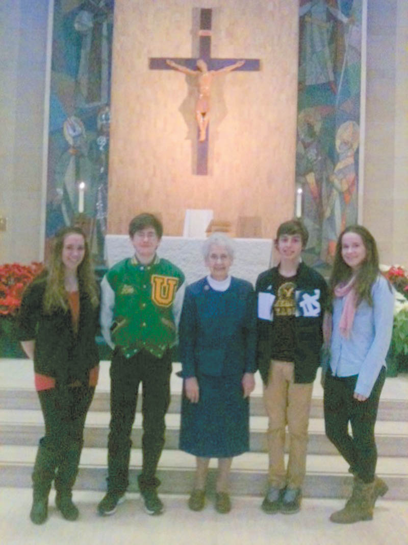 SPECIAL TO THE VINDICATOR — Holy Family Church Youth Ministry members and their families toured St. Columba Cathedral Jan. 18 with Sister Isabel Rudge, pastoral minister of the cathedral. After the tour, the Youth Ministry attended the 4 p.m. Mass and Liturgy of the Hours for Life. Standing with Sister Isabel, center, at the altar are, from left, Courtney Conklin, Mark Stein, Michael Puhalla and Ciara Kearns.