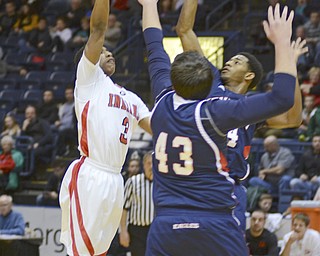 Katie Rickman | The Vindicator.Girard's DeOnte Brown (3) goes up for a basket and is blocked by JFK's AJ Grant(24) and Alec Pontikos(43) during the third period of the game at the Covelli Centre on Saturday, Jan. 24, 2015.