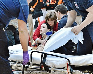 Jeff Lange | The Vindicator  Canfield's Lynne Whitehead (center) is comforted by her mother as medics prep the gurney. Whitehead was taken to the hospital after she suffered an injury to her neck and face during second half action of Canfield's game at Howland.