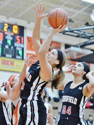 Jeff Lange | The Vindicator  Canfield's Savannah Barko (front) looks to make a shot as teammate Emily Ellis looks on from behind during second half action of Saturday's game at Howland High School.
