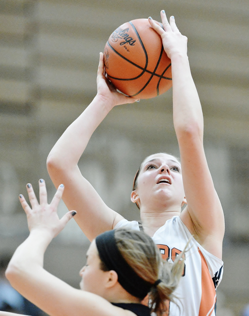 Jeff Lange | The Vindicator  Howland's Sara Price looks to make a shot over a Canfield defender in the second half of their game Saturday afternoon at Howland High School.