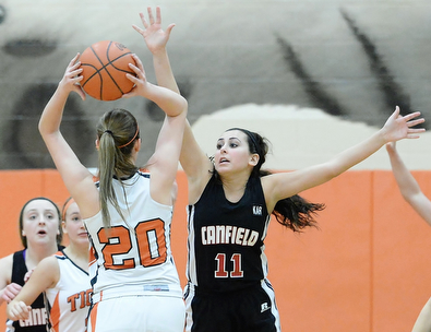 Jeff Lange | The Vindicator  Canfield's Ashley Kaleel (11) stretches out her arms to block the shot of Howland's Sara Price during their game Saturday at Howland High School.