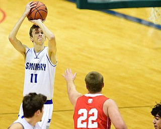 YOUNGSTOWN, OHIO - JANUARY 25, 2014: Matt Baker #11 of Poland shoot a open three beating the hand of Trey Staunch #22 of West Middlesex during the first half of Sunday evenings game at Covelli Centre. (Photo by David Dermer/Youngstown Vindicator)