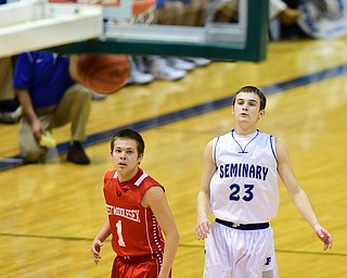 YOUNGSTOWN, OHIO - JANUARY 25, 2014: Jared Burkert #23 of Poland watches as his three point shot goes through the basket during the first half of Sunday evenings game at Covelli Centre. (Photo by David Dermer/Youngstown Vindicator) Andrew Long #1 of West Middlesex pictured.