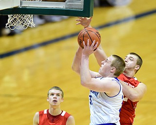 YOUNGSTOWN, OHIO - JANUARY 25, 2014: Dan Black #32 of Polans goes to the basket while Trey Staunch #22 of West Middlesex goes for the block during the first half of Sunday evenings game at Covelli Centre. (Photo by David Dermer/Youngstown Vindicator) Isaac Williams #11 of West Middlesex pictured.