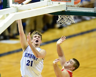 YOUNGSTOWN, OHIO - JANUARY 25, 2014: Kyle dixon #21 of Poland goes to the basket after getting past Trey Staunch #22 of West Middlesex during the first half of Sunday evenings game at Covelli Centre. (Photo by David Dermer/Youngstown Vindicator)